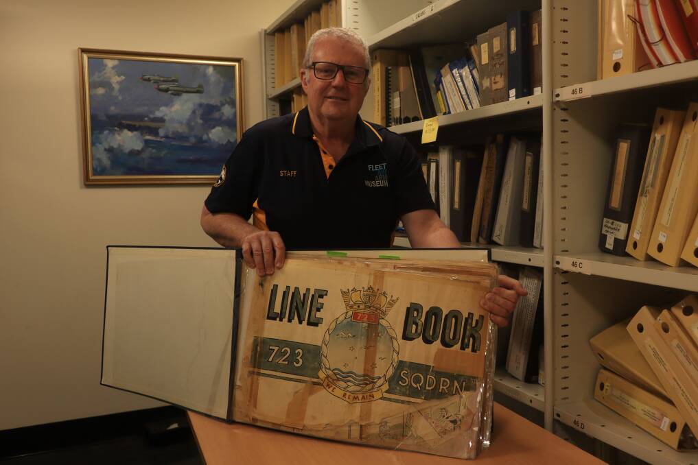 Fleet Air Arm Museum manager Stuart Harwood shows the 723 Squadron Line Book, which is preserved in the local archive. Picture by Jorja McDonnell.