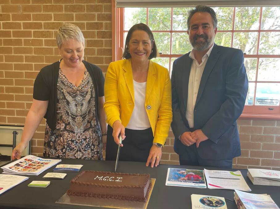 Federal Member for Gilmore, Fiona Phillips, is joined by Stella Vescio and Multicultural Communities Council of Illawarra CEO Chris Lacey as she cuts a cake during an Italian seniors group lunch in Nowra. Picture supplied.
