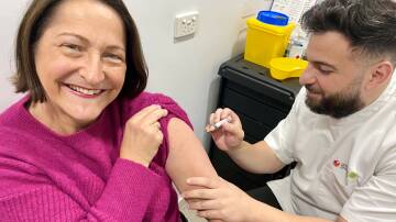 Federal Member for Gilmore Fiona Phillips gets her annual flu shot from pharmacist Ali Bazzi at Nowra's Priceline Pharmacy. Picture supplied.