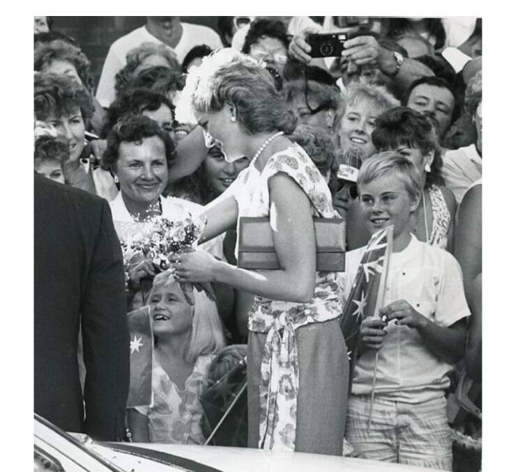 Princess Diana speaking to members of the crowd during a short meet and greet before the royal couple jumped back in their car.