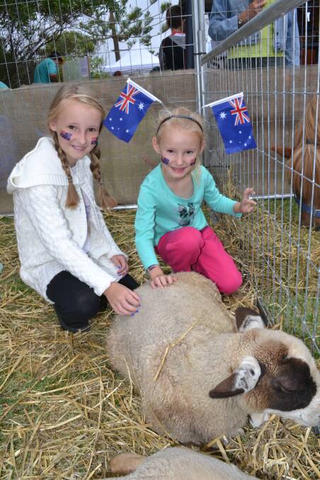 FAMILY FUN: Breanna and Page Fraser spent time patting a sheep in the patting zoo at the 2015 Mollymook Beach Australia Day event. The 2017 event will include Mollymook Beach markets, food stalls, music, games and more.