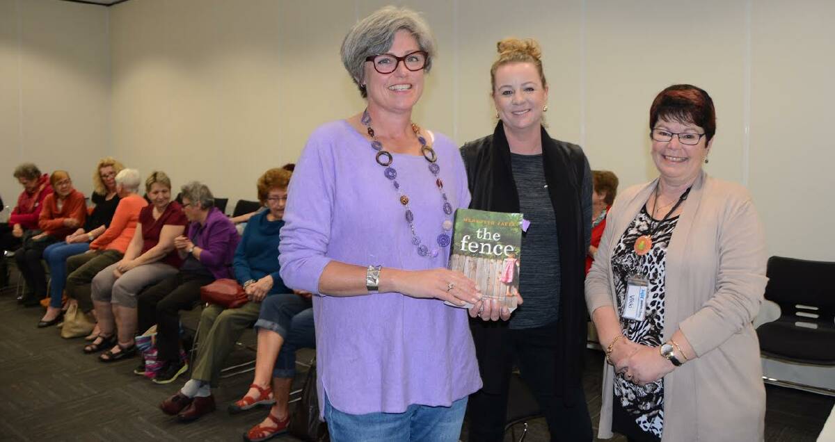 NOVEL EXPERIENCE: Meredith Jaffe (left) shares her book ‘The Fence’ with Ulladulla Library users and staff.