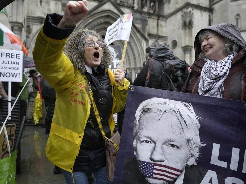 Julian Assange's supporters have gathered outside London's High Court as the legal battle unfolds. (AP PHOTO)